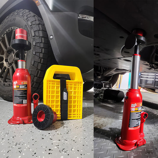 A red bottle jack with an extension and yellow stand is shown on a garage floor next to a lifted vehicle.