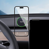 A Magnetic Wireless Charging Phone Holder from Tesery Official Store is mounted in a car, displaying a charging smartphone with the steering wheel in view—perfect for Model 3 Highland and Model Y Juniper owners.