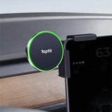 A Tesery Official Store Magnetic Wireless Charging Phone Holder for Model 3 Highland and Model Y Juniper with a green LED ring is mounted on a car dashboard, securely holding a smartphone near the instrument panel.
