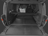 View of the LinerX Cargo Liner for 2022-2026 Rivian R1S in an SUV’s open trunk, with rear seats partially folded and a white car seat—showing all-weather protection and ideal fit for your Rivian R1S.