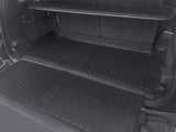 The image displays the LinerX Cargo Liner for 2022-2026 Rivian R1S by LinerX, shown in the cargo area with black rubber mats and upright rear seats, offering all-weather protection—an ideal practical accessory for your Rivian R1S.