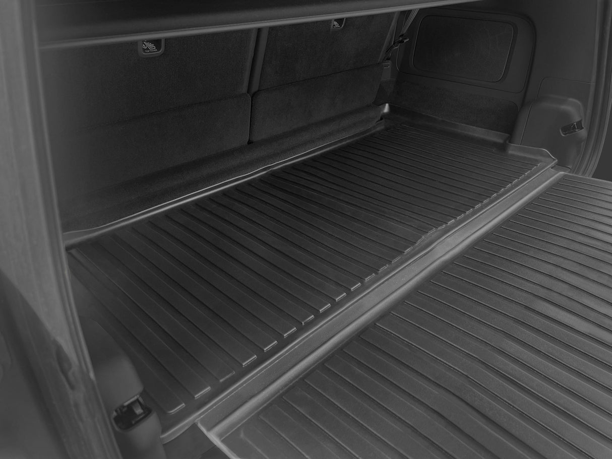 The photo displays the spacious cargo area of a Rivian R1S with seats folded and a LinerX Cargo Liner, offering all-weather protection—an ideal functional accessory for 2022-2026 models from the brand LinerX.