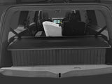 A rear view of the SUV shows a baby bassinet on the back seat, folded rear seats, and a LinerX Cargo Liner for 2022-2026 Rivian R1S—ideal all-weather protection for families upgrading their Rivian R1S with top accessories.
