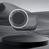 A round black device labeled Tesery Official Store sits on a black stand with a desert-like background, highlighting its sleek design as the Magnetic Dashboard Phone Mount for Model 3 Highland/Model Y Juniper.
