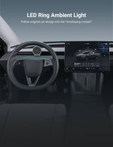 Car interior featuring the Tesery Official Store MagSafe Phone Mount for Model Y and Model 3, attached near the steering wheel with an LED ring light and a central touchscreen display showing a car interface.