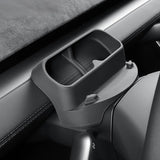 A close-up of the Tesery Official Store Sunglasses & Phone Holder Organizer for Model Y Juniper, a black plastic storage accessory on the car dashboard, ideal for Tesla owners seeking seamless interior upgrades.