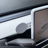 A Tesery Official Store Wireless Magsafe Mount for Tesla Model 3/Y/S/X/Cybertruck is attached to a white dashboard trim near the touchscreen display, with the gear selector (P, R, N, D) visible in the foreground.