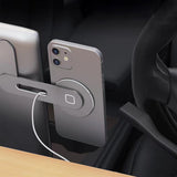 A smartphone is attached to the Tesery Official Store Wireless Magsafe Mount for Tesla Model 3/Y/S/X/Cybertruck, which is mounted on the car vent with a charging cable plugged into the mount.